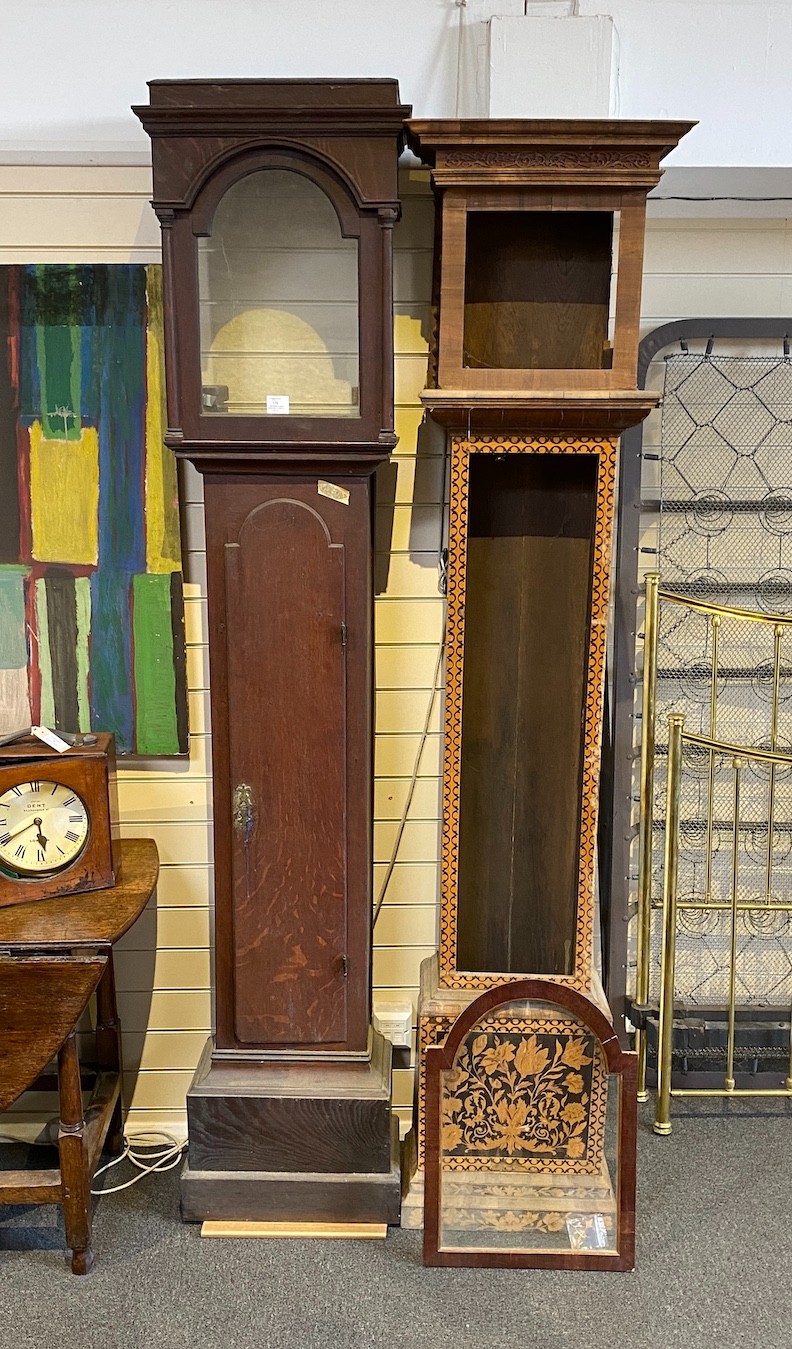 A George III oak longcase clock case and an inlaid clock case, larger 222 cm high.